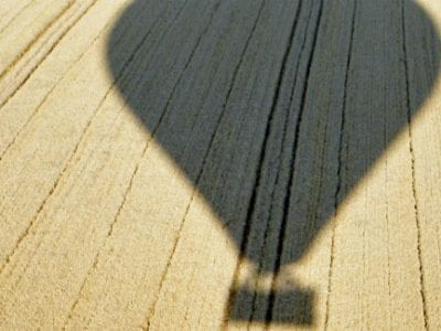 hot air balloon silhouette on corn field